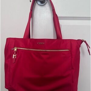 TUMI red bag- pre owned. The inside is clean.